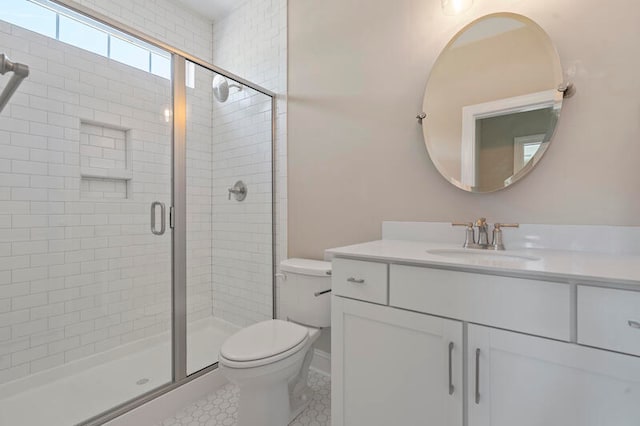 bathroom with toilet, vanity, walk in shower, and tile patterned floors