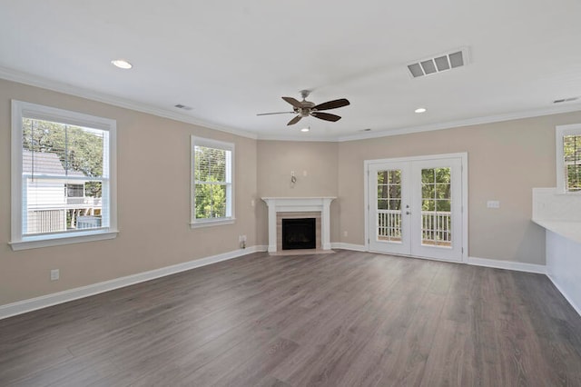 unfurnished living room with ceiling fan, crown molding, french doors, and dark hardwood / wood-style floors