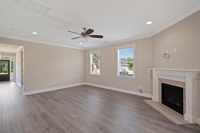 unfurnished living room with a wealth of natural light, ceiling fan, hardwood / wood-style floors, and a fireplace