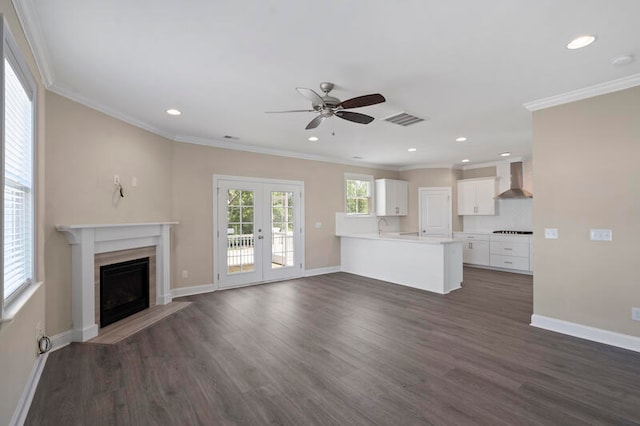 unfurnished living room with ornamental molding, a wealth of natural light, french doors, and dark wood-style floors