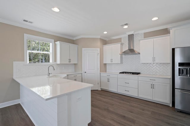 kitchen with backsplash, wall chimney exhaust hood, dark hardwood / wood-style floors, and stainless steel refrigerator with ice dispenser