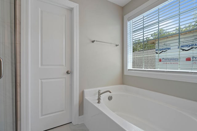 full bathroom with a garden tub and a shower with shower door