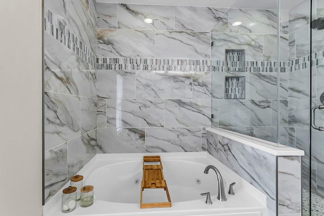 full bathroom featuring a shower and a jetted tub