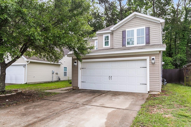 view of front of home with concrete driveway, an attached garage, and fence