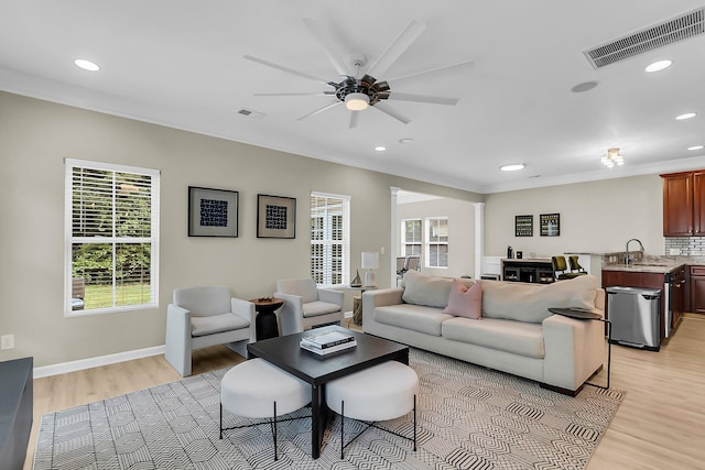 living room featuring light wood-style floors, a ceiling fan, recessed lighting, and visible vents