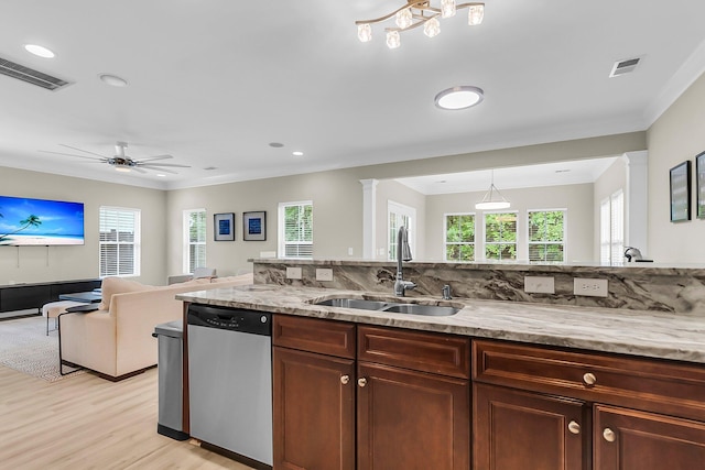kitchen featuring visible vents, light stone countertops, a sink, light wood finished floors, and dishwasher