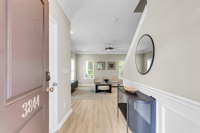 hallway featuring recessed lighting, baseboards, ornamental molding, and light wood-type flooring