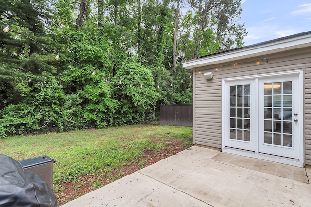 view of yard featuring a patio area and french doors