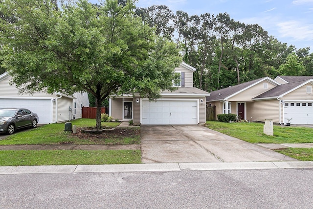 view of front of house featuring fence, an attached garage, driveway, and a front lawn