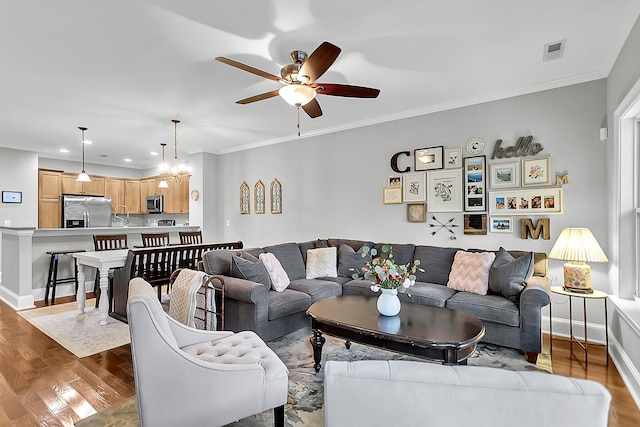 622 Windermere Blvd Unit D, Charleston, SC 29407 - living room with ceiling fan, wood finished floors, ornamental molding, a chandelier, and baseboards