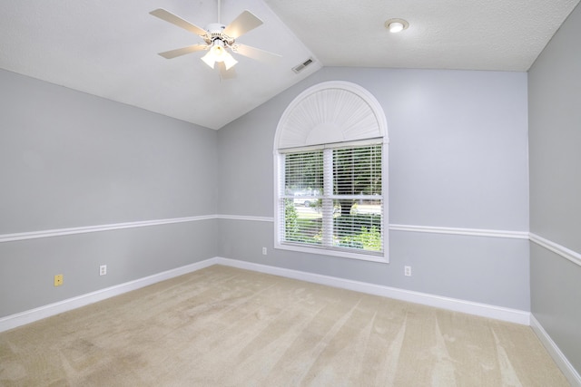 spare room featuring carpet, visible vents, baseboards, and ceiling fan