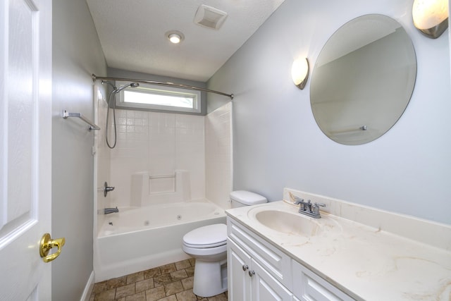 bathroom with toilet, vanity, shower / washtub combination, and a textured ceiling