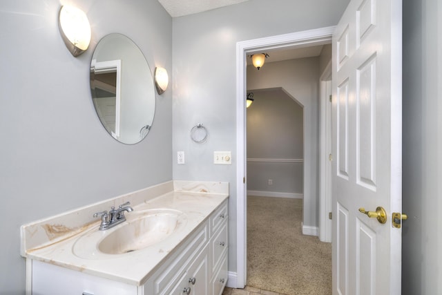 bathroom featuring vanity and baseboards