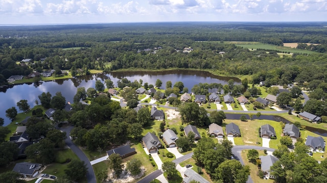 birds eye view of property featuring a wooded view, a residential view, and a water view