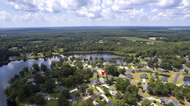 birds eye view of property featuring a wooded view and a water view