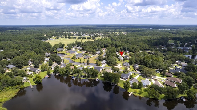 drone / aerial view with a view of trees, a residential view, and a water view