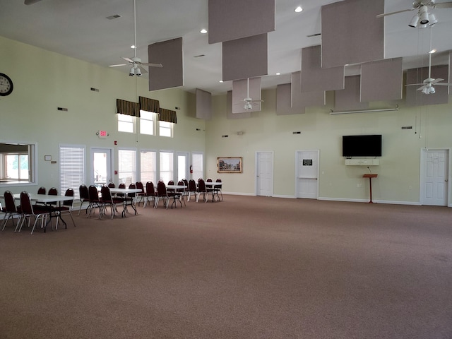 miscellaneous room featuring a towering ceiling, a ceiling fan, recessed lighting, carpet flooring, and baseboards
