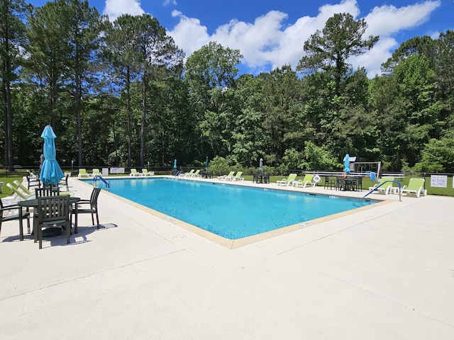pool featuring a patio area and fence
