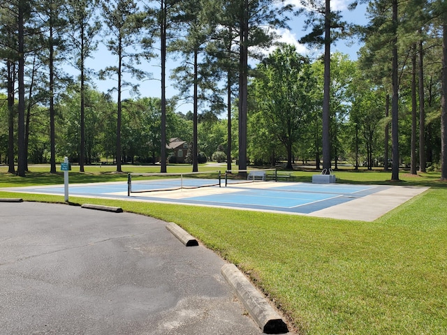 view of sport court featuring a yard