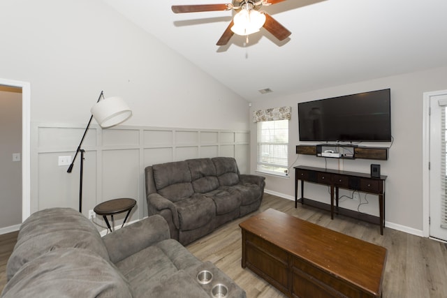 living room featuring lofted ceiling, light hardwood / wood-style floors, and ceiling fan