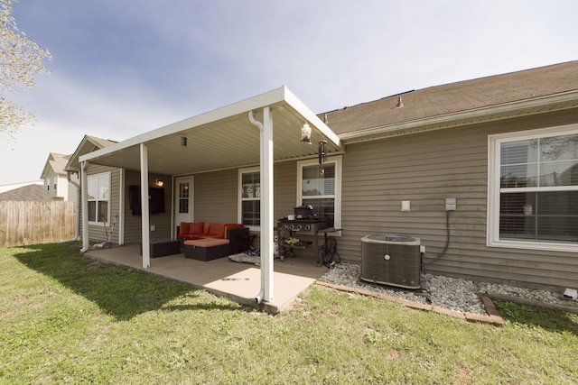 back of house with a patio, central AC, outdoor lounge area, and a lawn