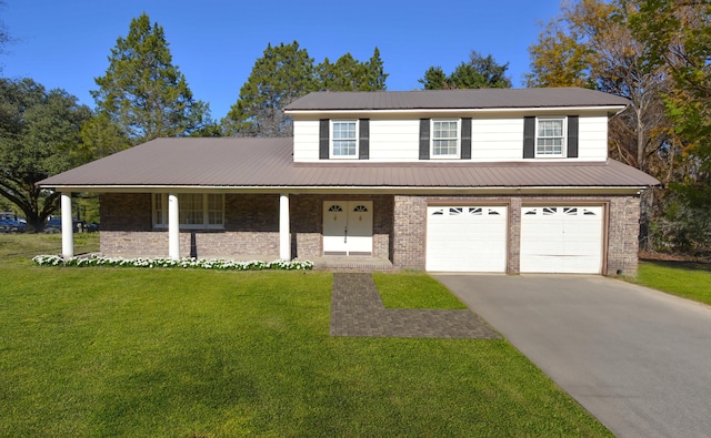 view of property featuring a front lawn, covered porch, and a garage