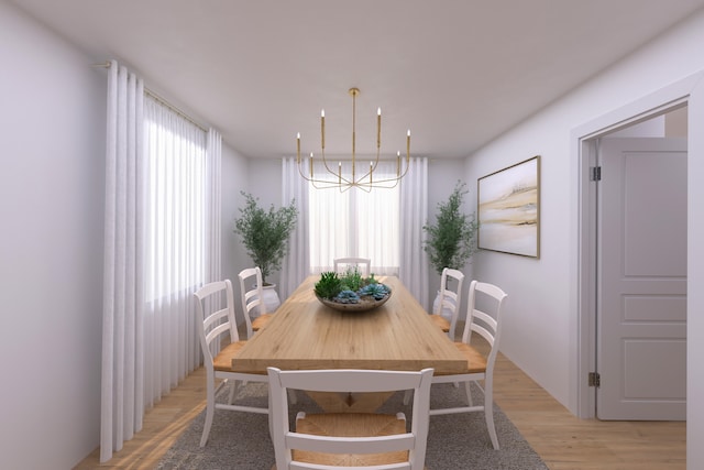 dining area with light hardwood / wood-style flooring and a notable chandelier