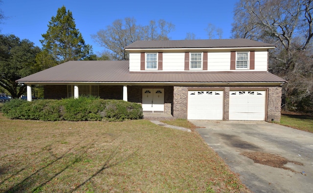 view of front property featuring covered porch, a garage, and a front yard