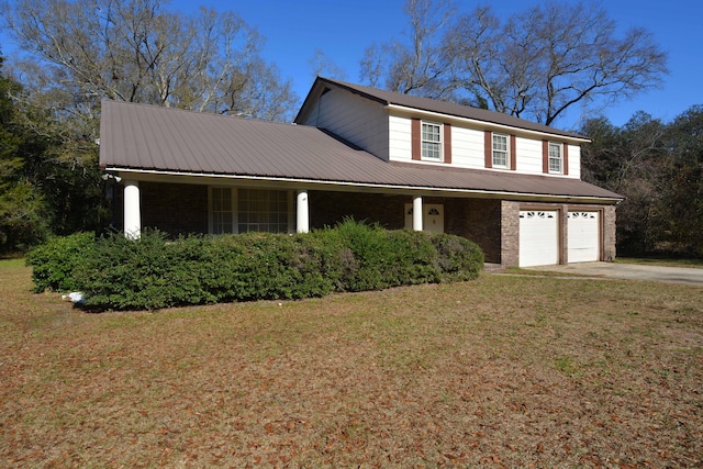 view of front of home with a front lawn and a garage