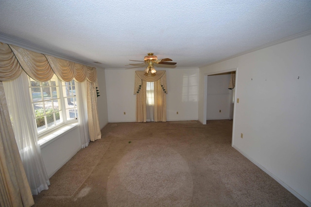 spare room with carpet flooring, ceiling fan, and a textured ceiling