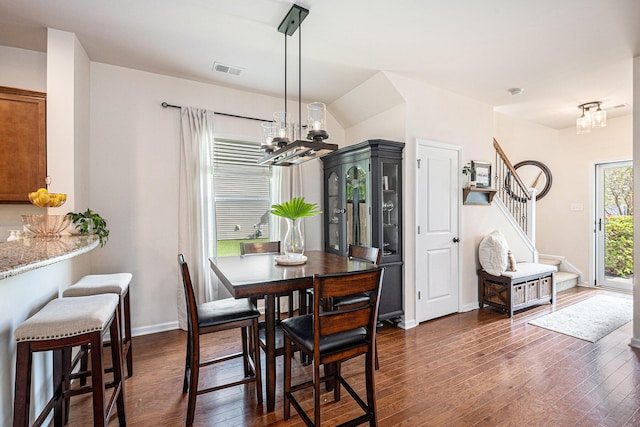 1723 Indaba Way, Charleston, SC 29414 - dining area featuring a chandelier, dark wood-style floors, stairway, and baseboards