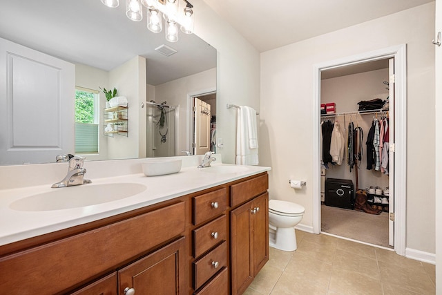 1723 Indaba Way, Charleston, SC 29414 - bathroom featuring a stall shower, double vanity, tile patterned floors, baseboards, and a walk in closet