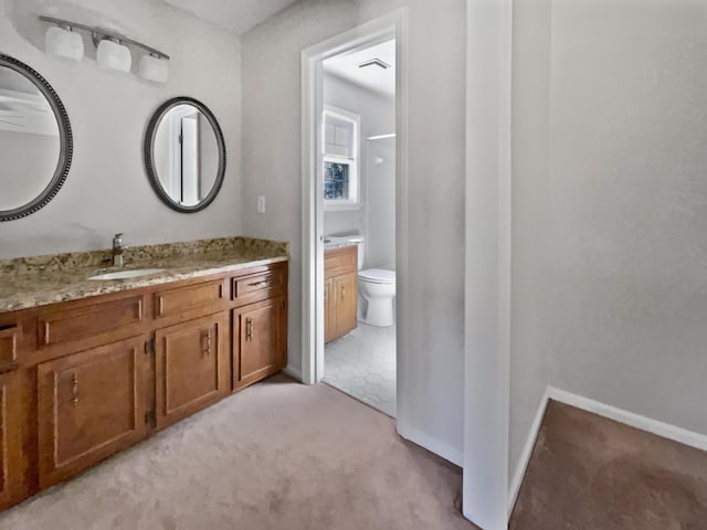 bathroom featuring vanity and toilet