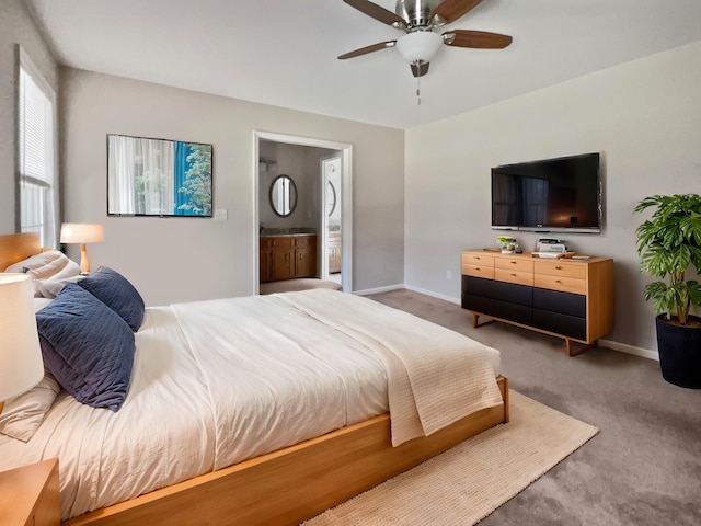 bedroom with carpet flooring, connected bathroom, and ceiling fan