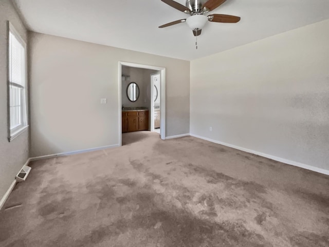 carpeted spare room featuring ceiling fan