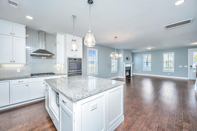 415 Watergrass Way, Summerville, SC 29485 - kitchen featuring stainless steel appliances, open floor plan, visible vents, and wall chimney exhaust hood