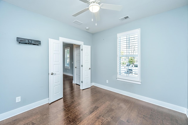 415 Watergrass Way, Summerville, SC 29485 - unfurnished bedroom featuring dark wood-style flooring, visible vents, baseboards, and ceiling fan