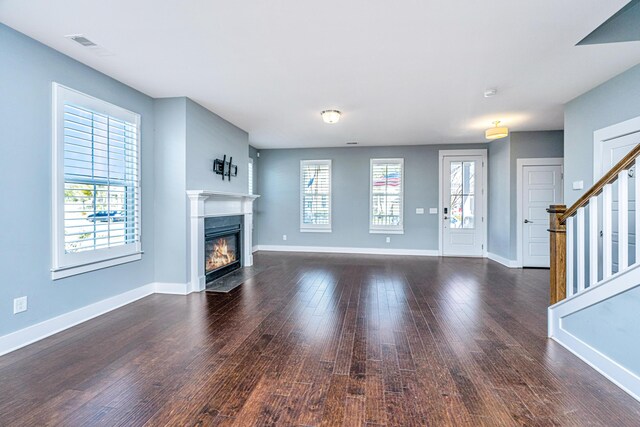 415 Watergrass Way, Summerville, SC 29485 - unfurnished living room with plenty of natural light, a fireplace with flush hearth, dark wood-style floors, and baseboards