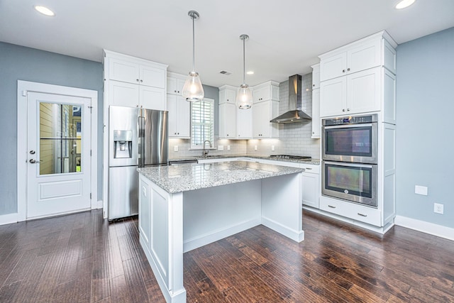 415 Watergrass Way, Summerville, SC 29485 - kitchen with dark wood-style floors, a center island, wall chimney exhaust hood, stainless steel appliances, and a sink
