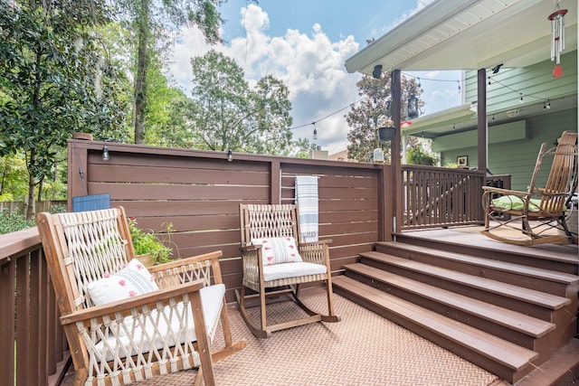 deck with a patio area and fence