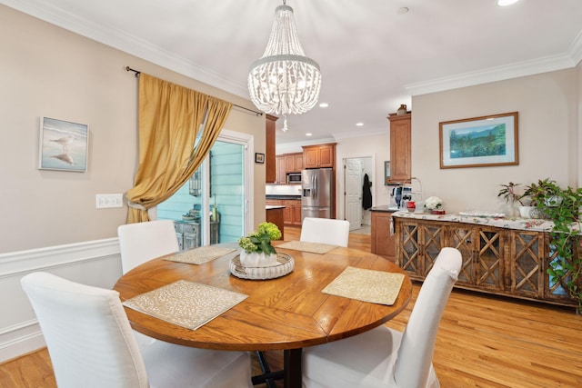 dining room with a notable chandelier, light wood finished floors, recessed lighting, and crown molding