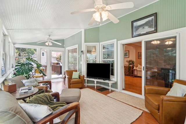 sunroom / solarium with lofted ceiling and a ceiling fan