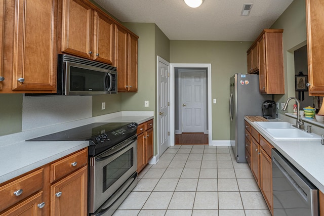 105 Northpark Ave, Summerville, SC 29485 - kitchen with appliances with stainless steel finishes, a sink, brown cabinets, light countertops, and a textured ceiling