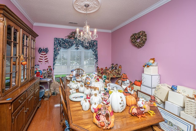105 Northpark Ave, Summerville, SC 29485 - dining area featuring a chandelier, light wood-style floors, crown molding, and a textured ceiling