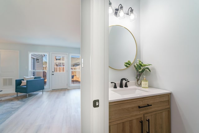 bathroom featuring hardwood / wood-style flooring and vanity