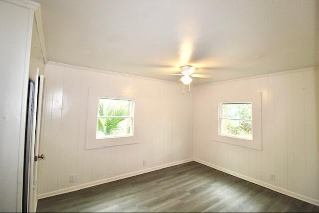 1925 Kerry St, North Charleston, SC 29406 - unfurnished room with dark wood-type flooring, ornamental molding, ceiling fan, and baseboards