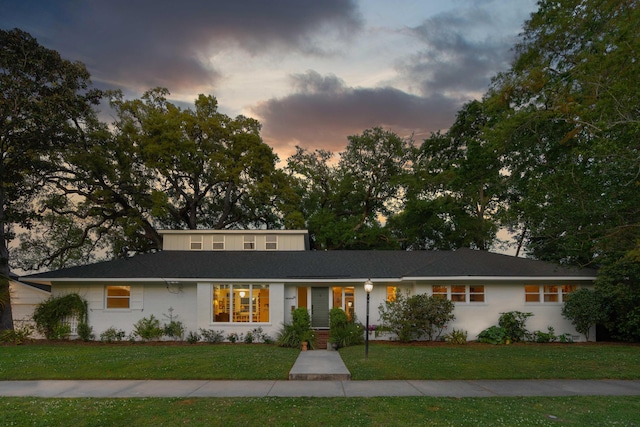 view of front of property with a lawn