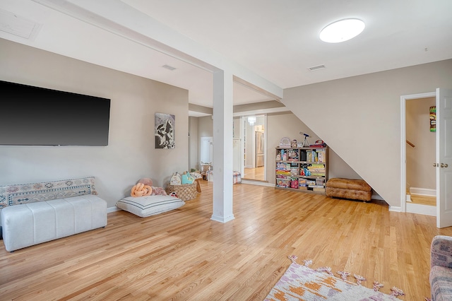 interior space with visible vents, baseboards, and wood finished floors