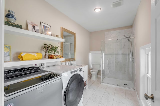 full bath featuring marble finish floor, a marble finish shower, visible vents, toilet, and separate washer and dryer