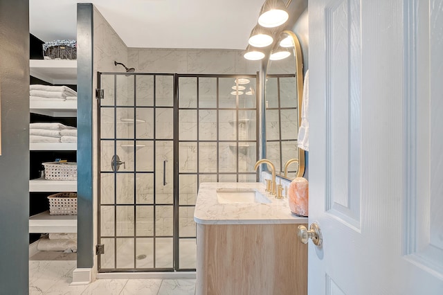 full bath featuring a stall shower, marble finish floor, and vanity